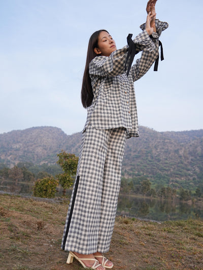 Woman wearing the Sutra Balloon Sleeve Check co-ord — a checked cotton top with balloon sleeves and wide-leg pants