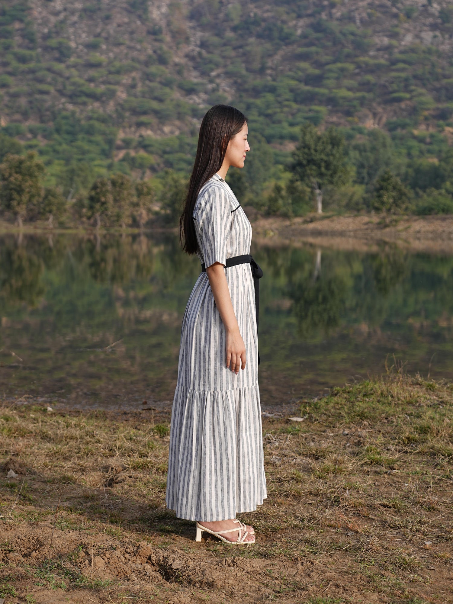 Side profile of the striped cotton midi dress, showing its relaxed drape
