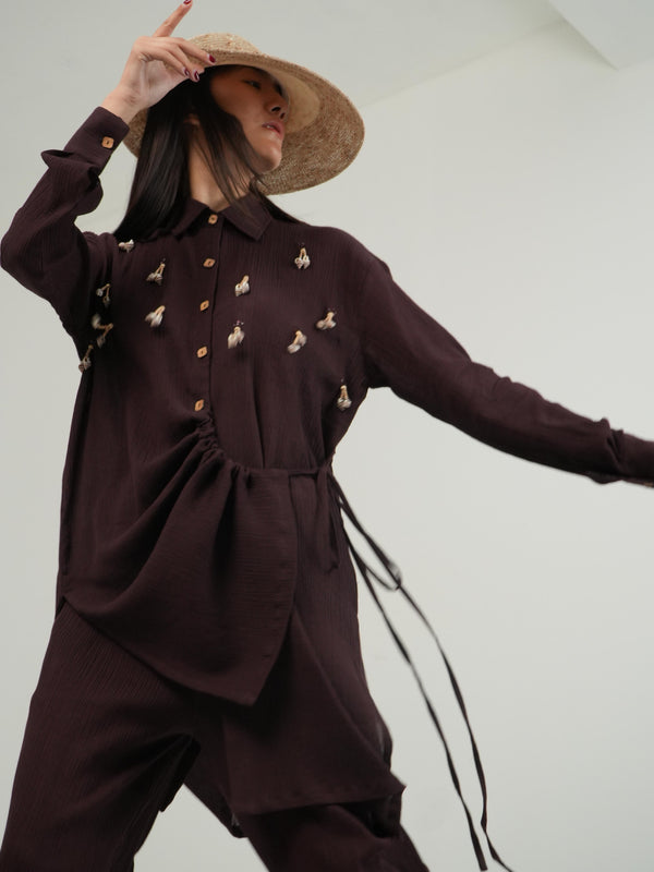 Woman wearing the Vanshitaaz Deep Burgundy crinkled cotton co-ord — a wrap-style top with flowing wide-leg pants