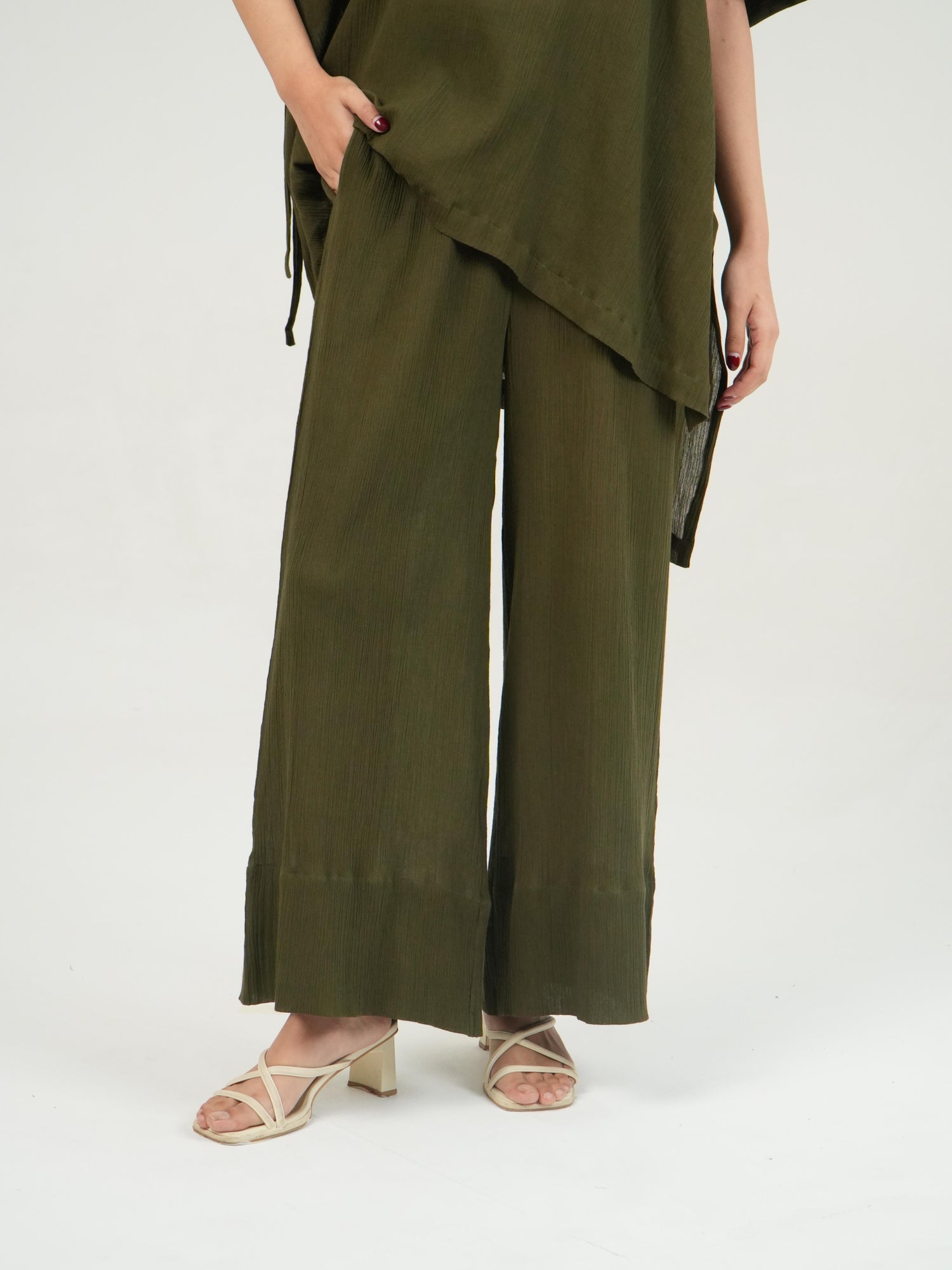 Side profile of the Olive crinkled cotton co-ord set, showing its relaxed drape