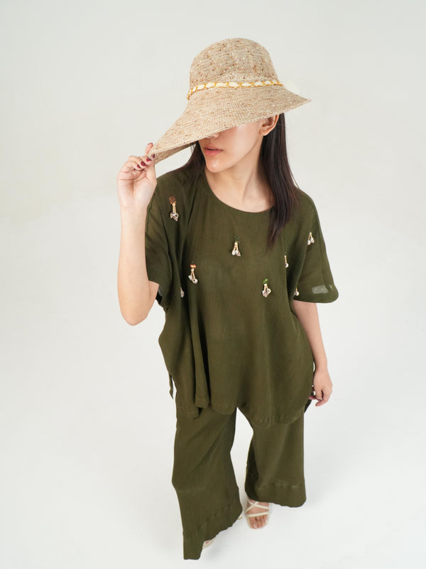 Woman wearing the Vanshitaaz Olive crinkled cotton co-ord — an oversized short-sleeve top with wide-leg olive pants
