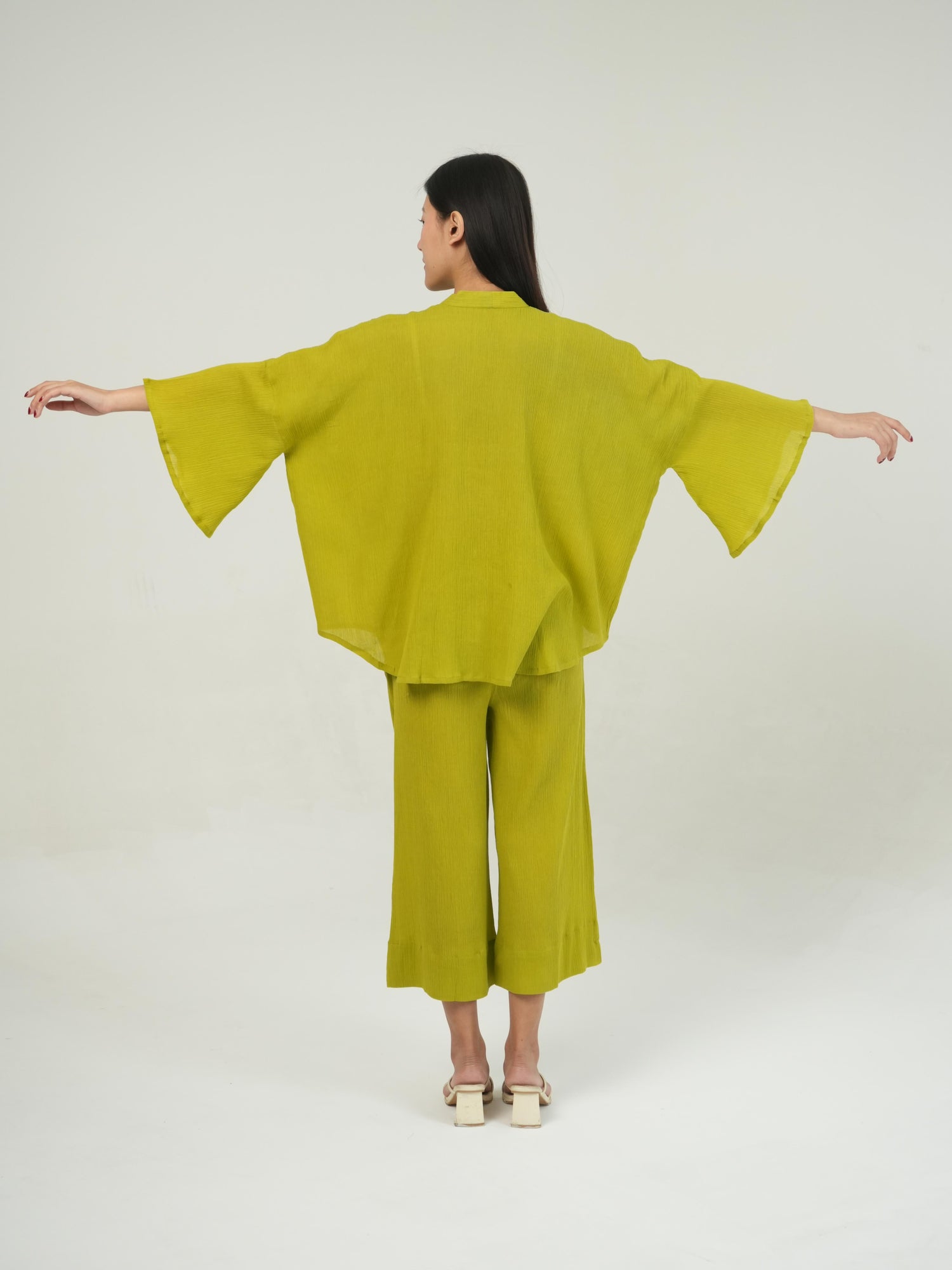Close-up of the crinkled cotton texture and subtle embellishment