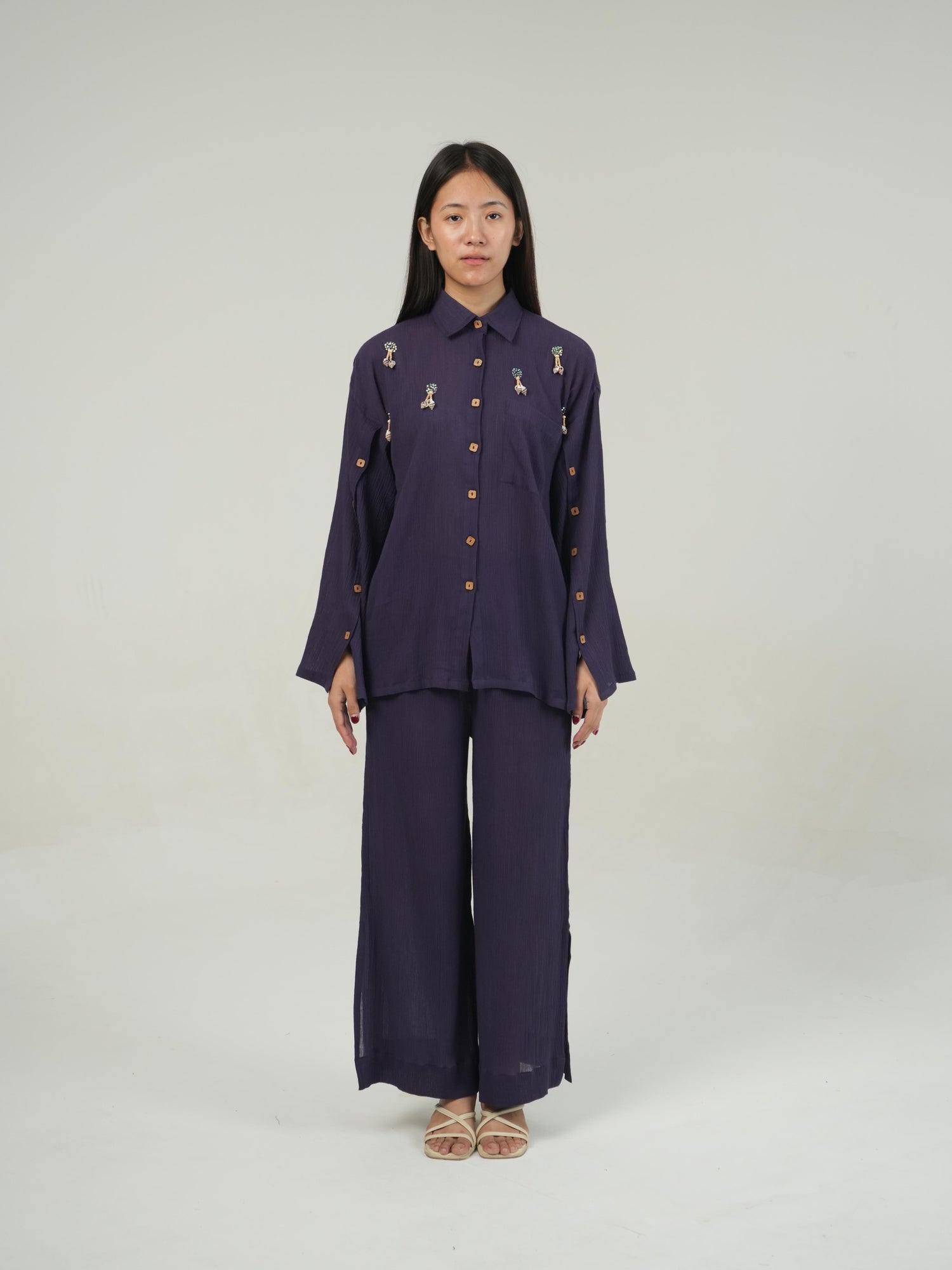 Close-up of the crinkled cotton texture and subtle embellishment