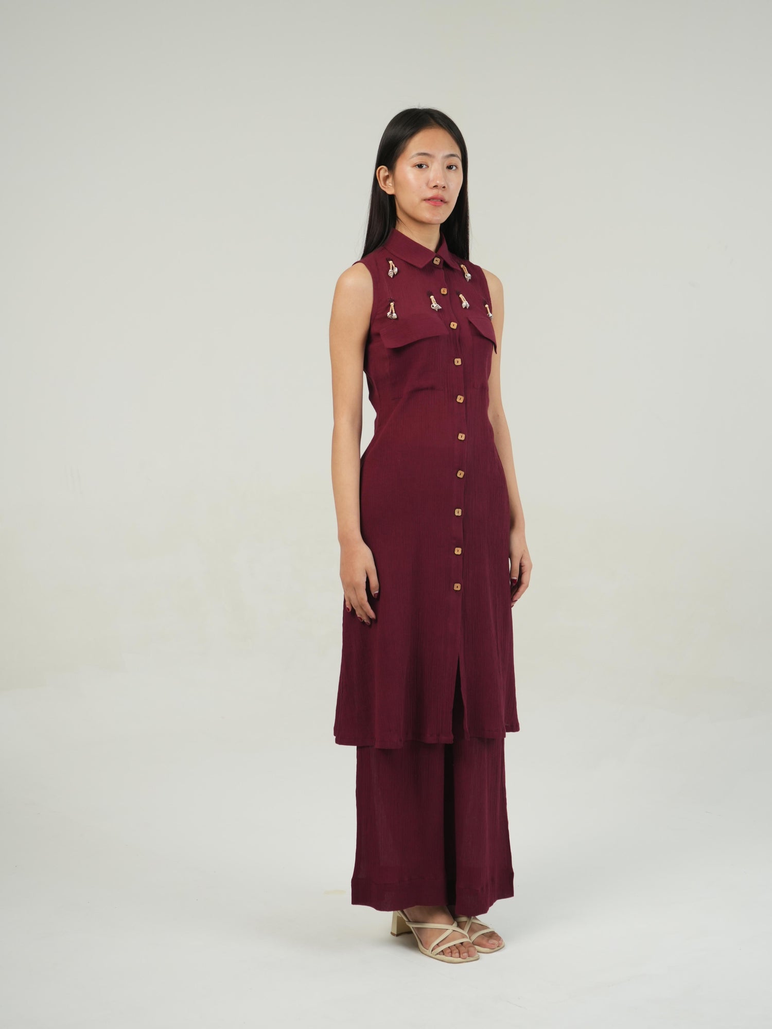 Close-up of the crinkled cotton texture and subtle embellishment