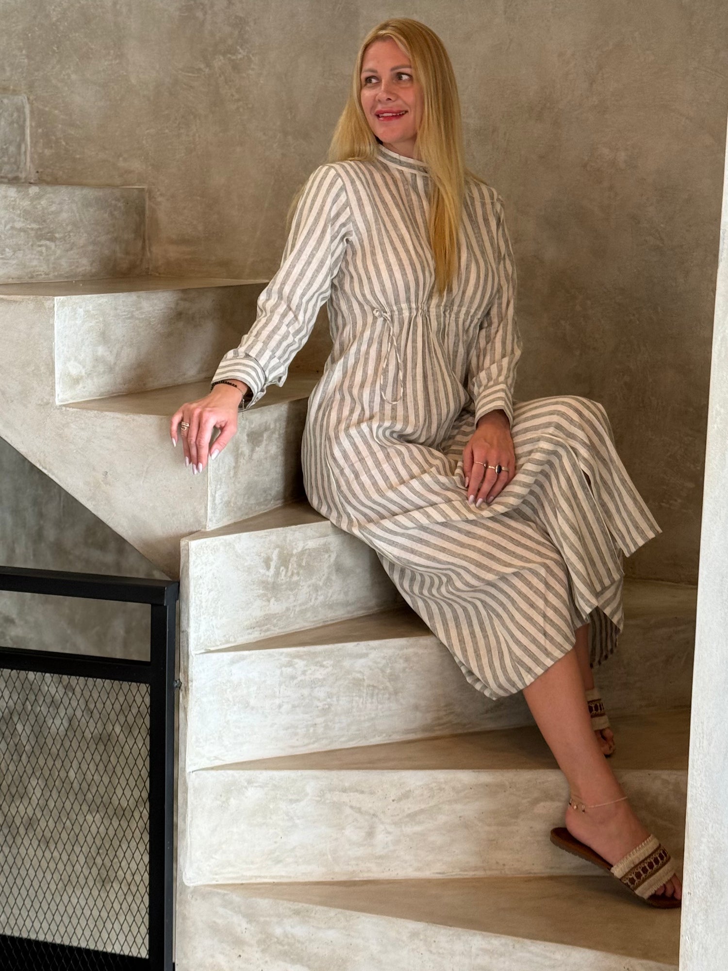 The high neckline and full-length sleeves of the striped cotton maxi dress