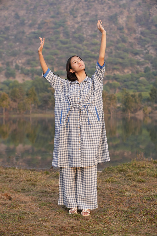 Woman wearing the Sutra Anti-Fit Check co-ord — a boxy checked cotton top with straight palazzo pants