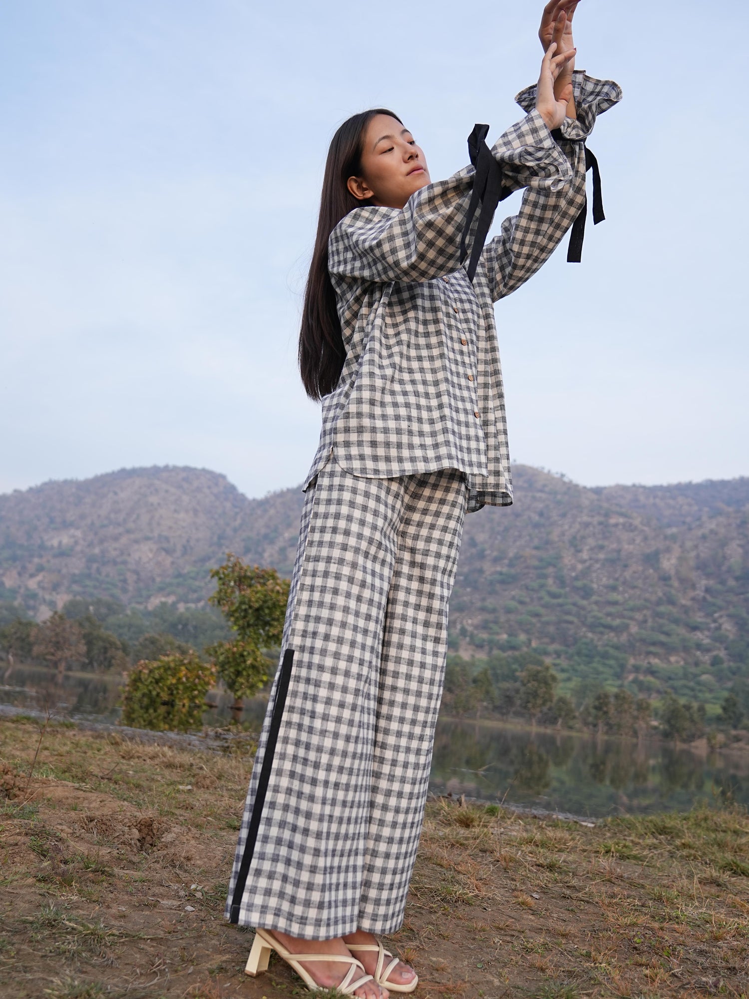 Woman wearing the Sutra Balloon Sleeve Check co-ord — a checked cotton top with balloon sleeves and wide-leg pants