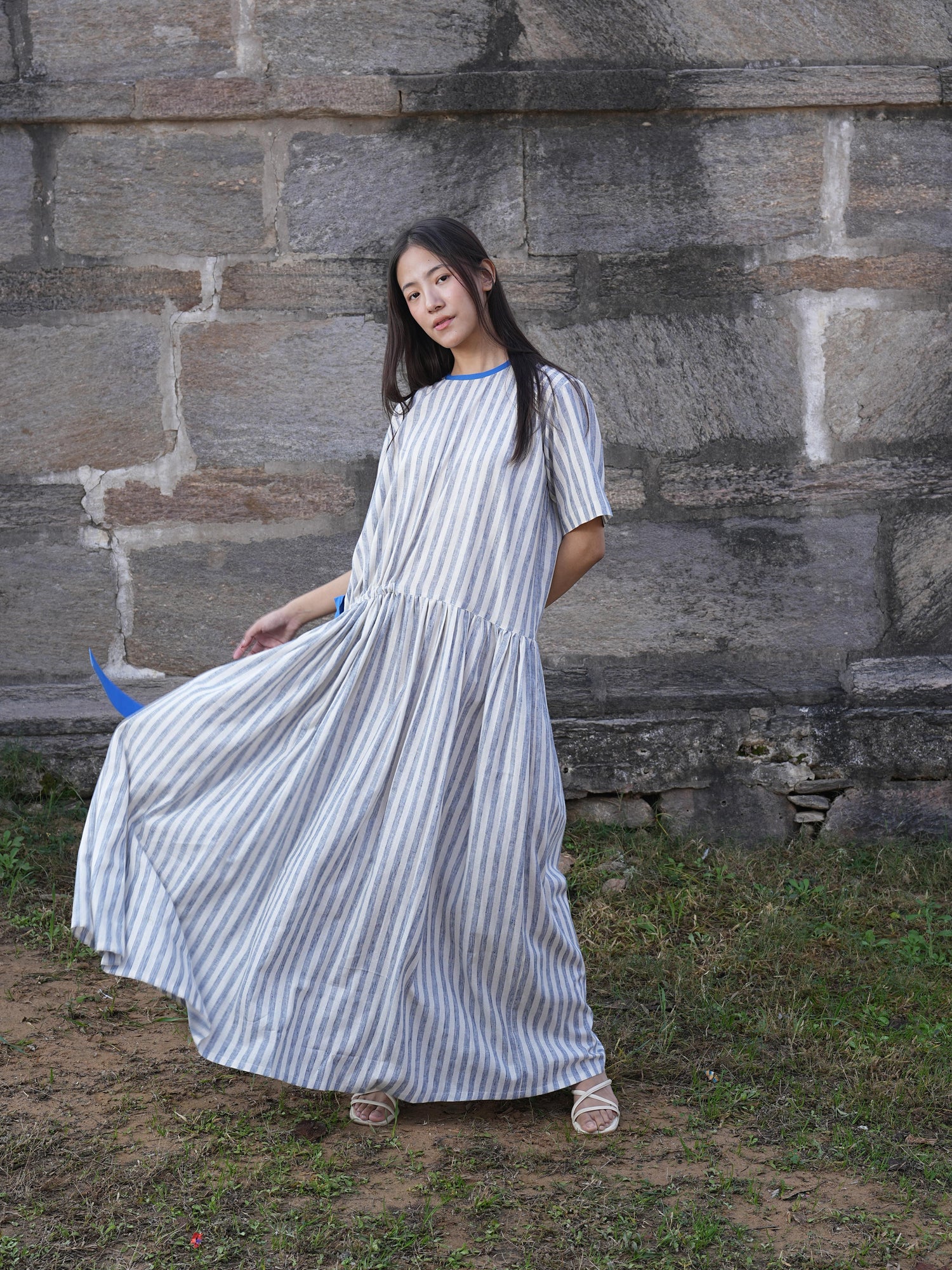Side profile of the striped cotton dress, showing its relaxed drape