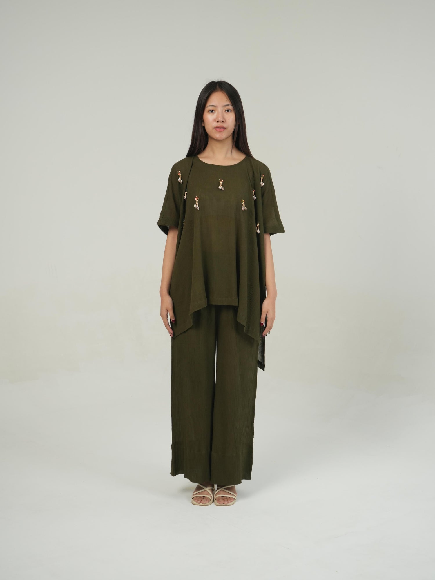 Model styling the Olive crinkled cotton co-ord set for a resort or beach day