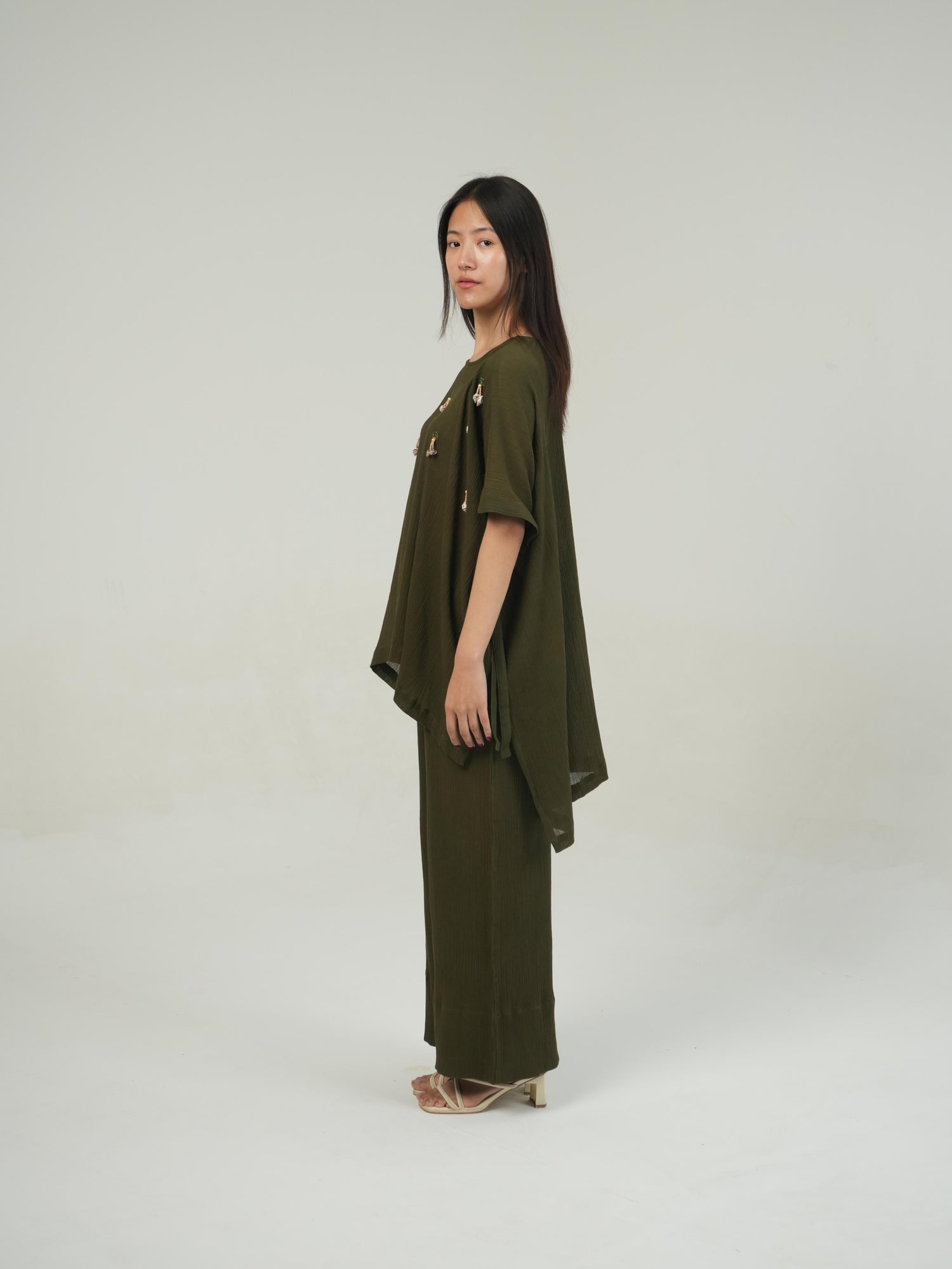 Relaxed, loose-fit Olive crinkled cotton co-ord set shown in natural daylight